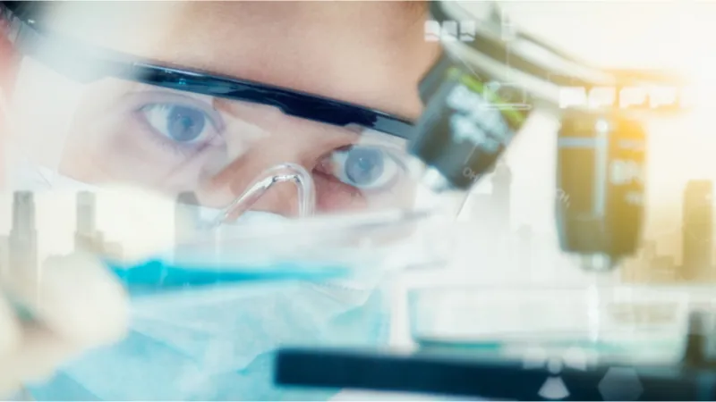 Researcher using a microscope