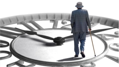 Old man walking on a clock